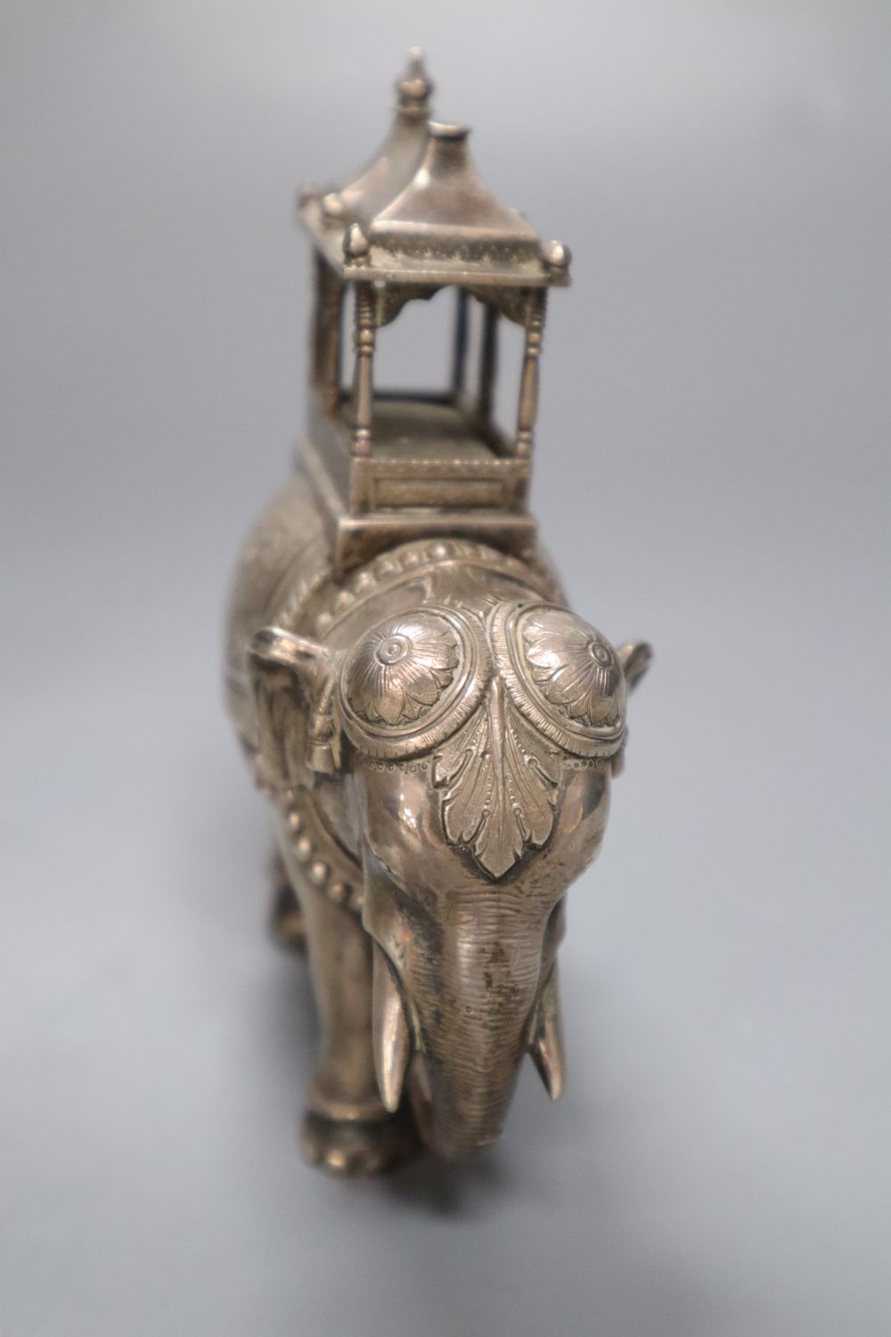 A pair of cast silver plated models of ceremonial elephants, 11cm high